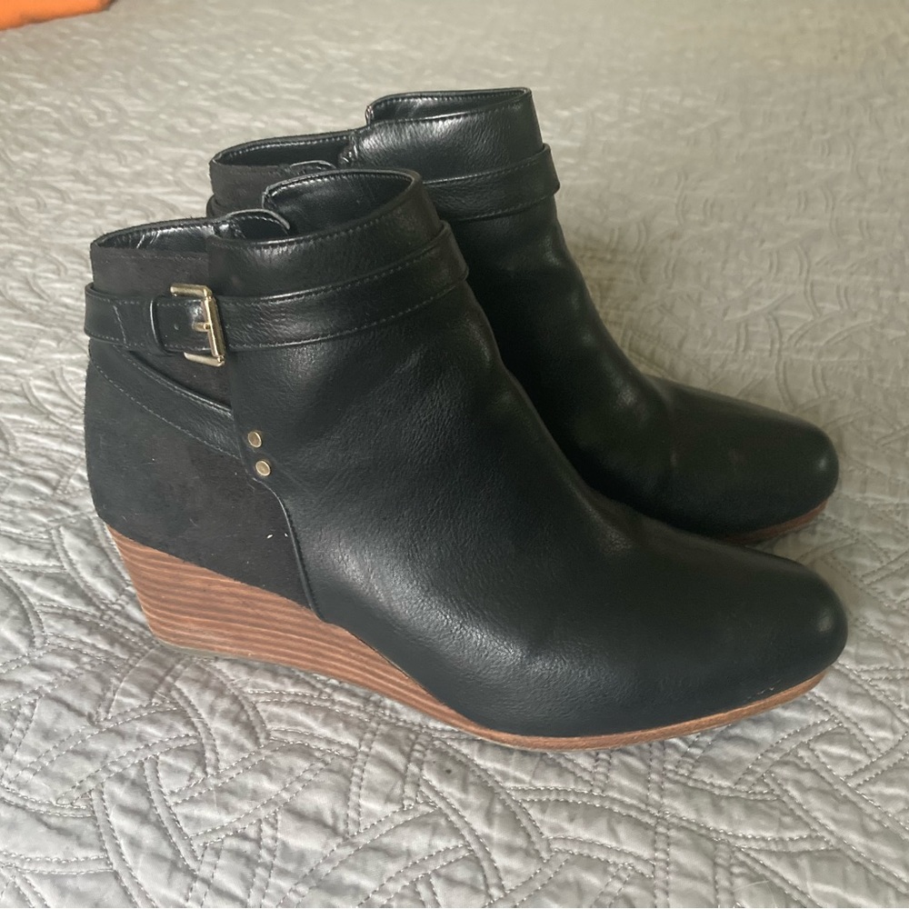 Black ankle boots with zipper and gold accents